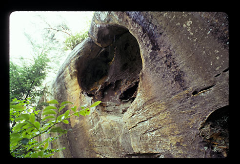 A hole in the side of the cliff.